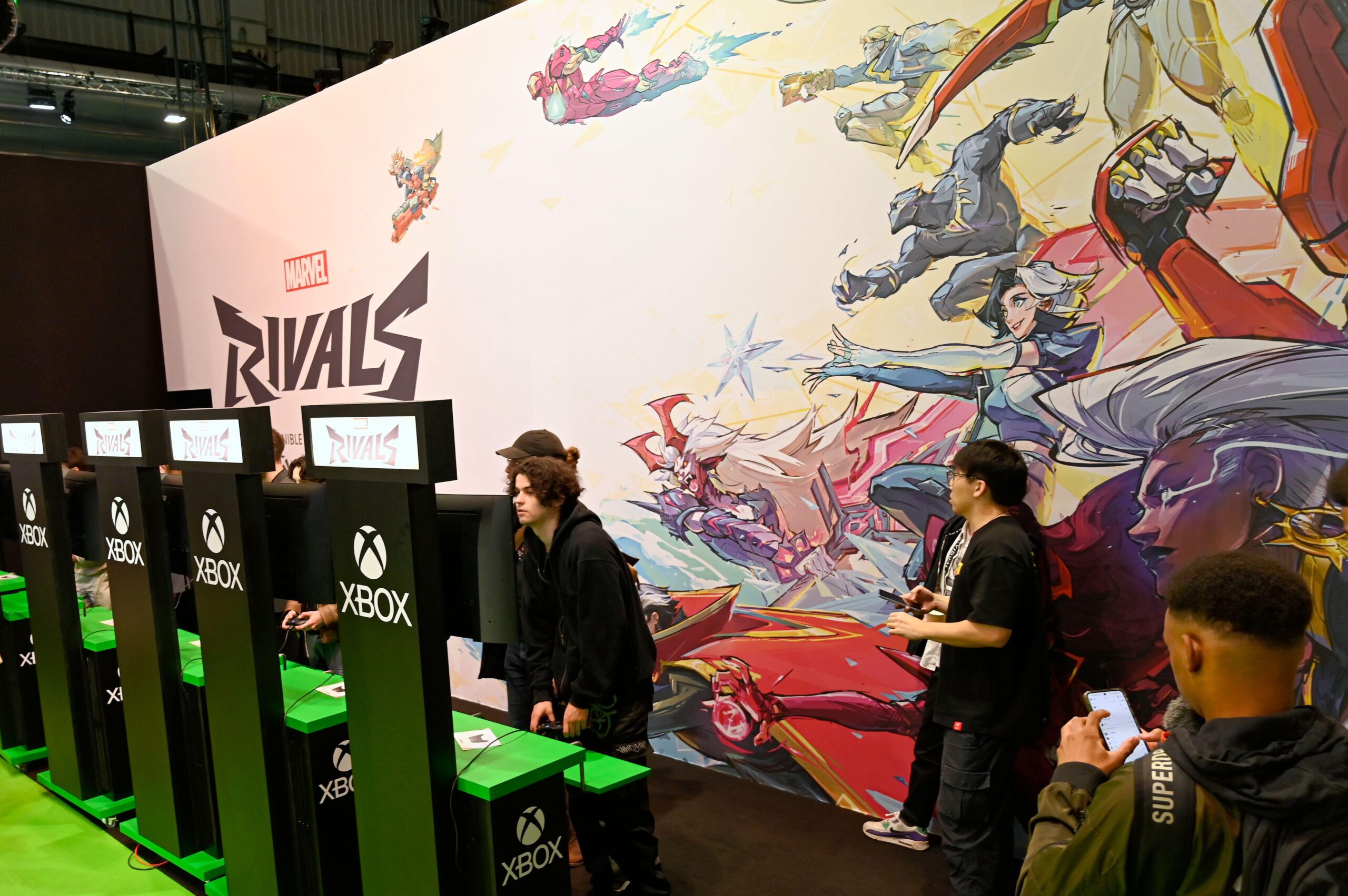 people playing Marvel Rivals in a convention