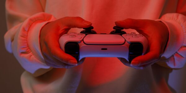 a person playing The Midnight Walk on Playstation 5 with red lights in the room