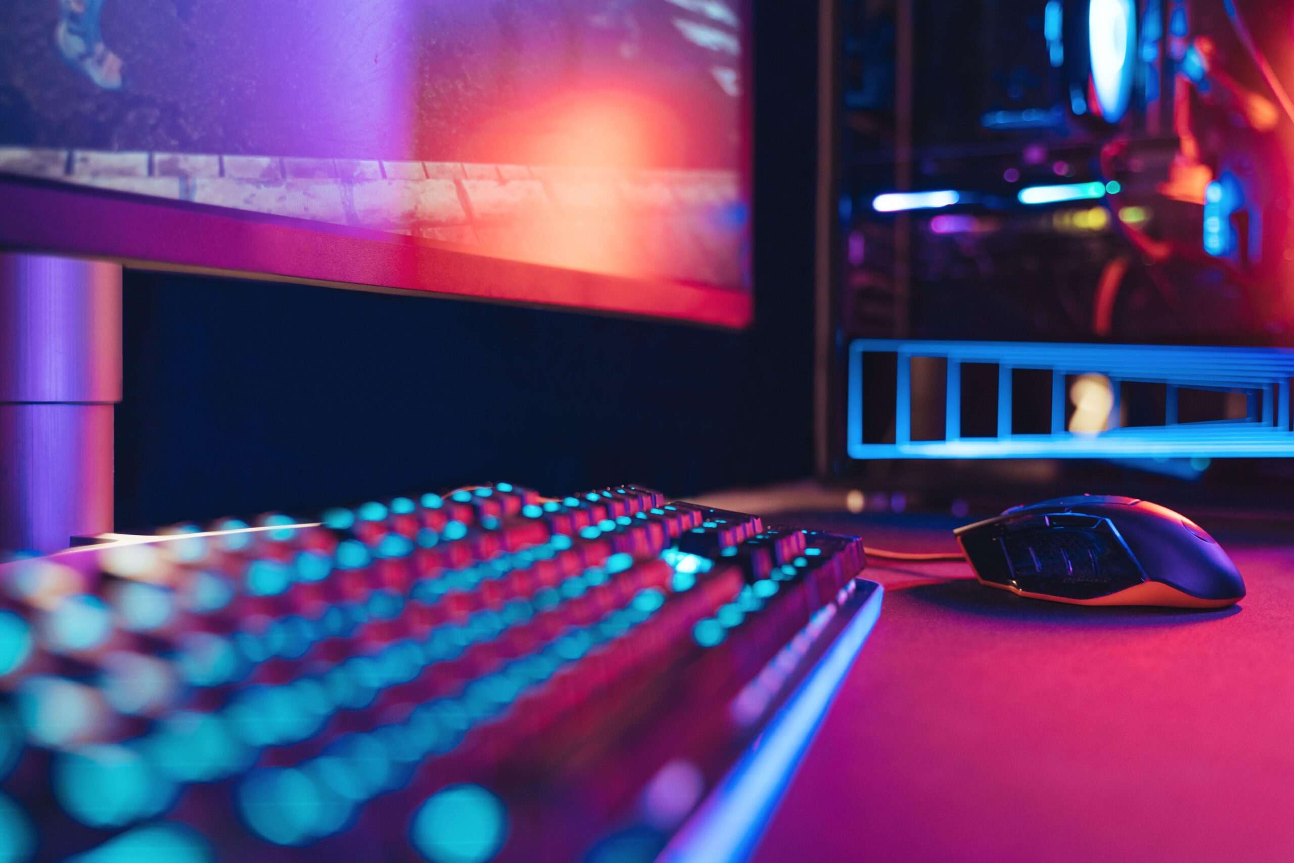 a PC setup with RGB lights with Nightreign playing on the monitor