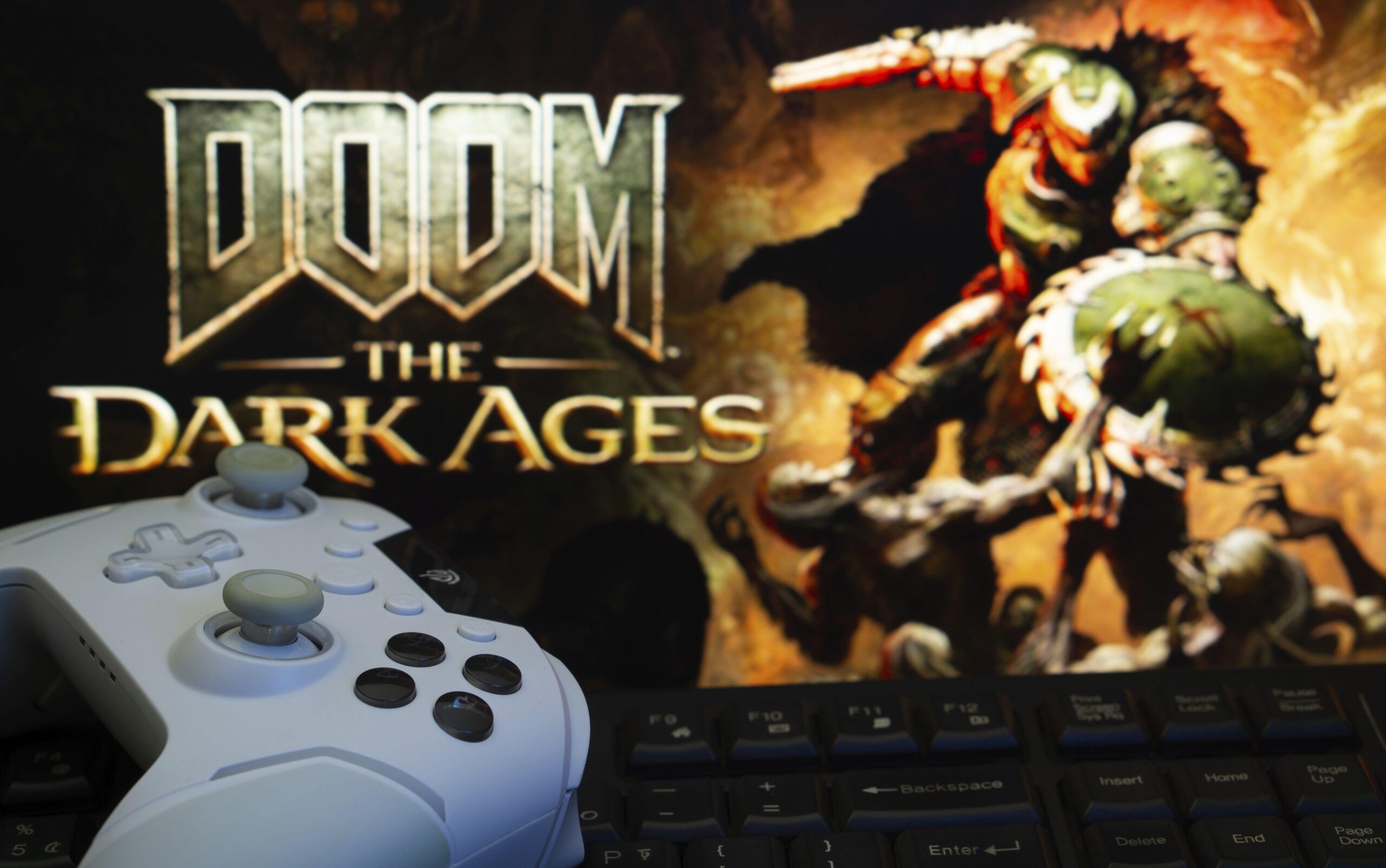 Doom: The Dark Ages on the TV with a white X Box controller in front of it